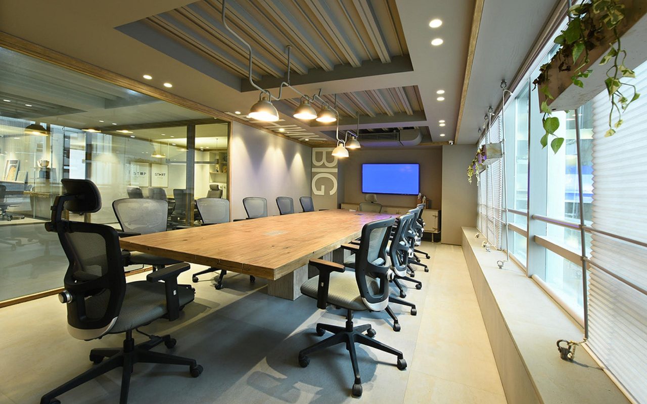 Sleek and modern empty conference room with stylish swivel chairs and a wooden table.