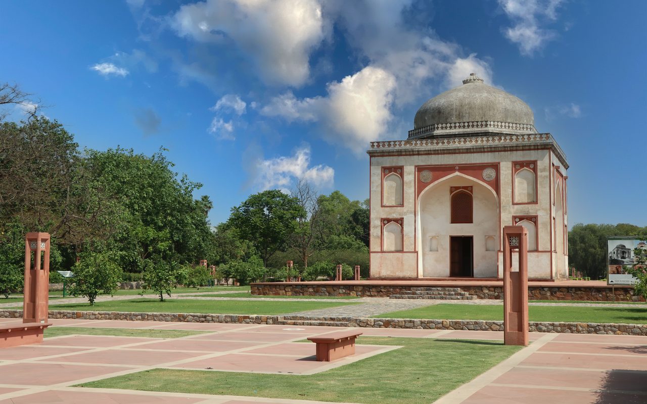 Historic Mughal mausoleum at Sunder Nursery, New Delhi, on a sunny day.