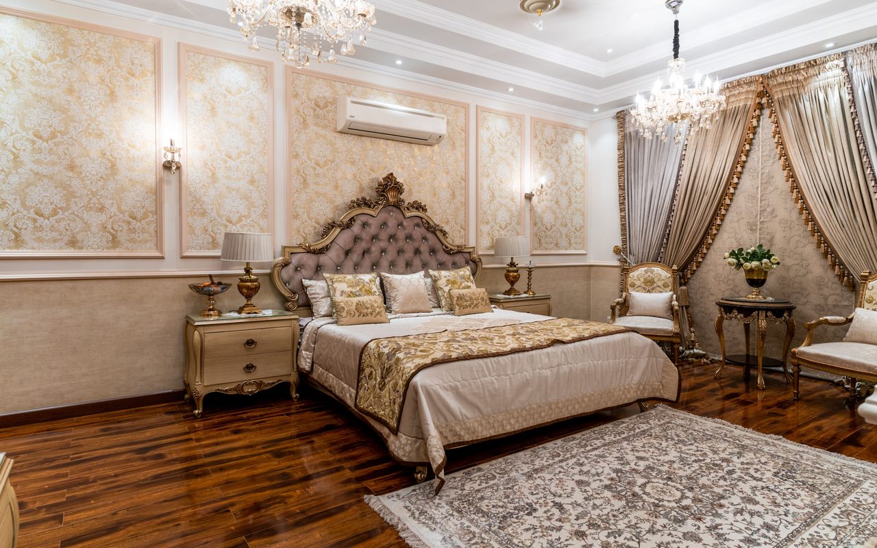 elegance with a luxurious hotel suite featuring ornate chandeliers and vintage furniture.
