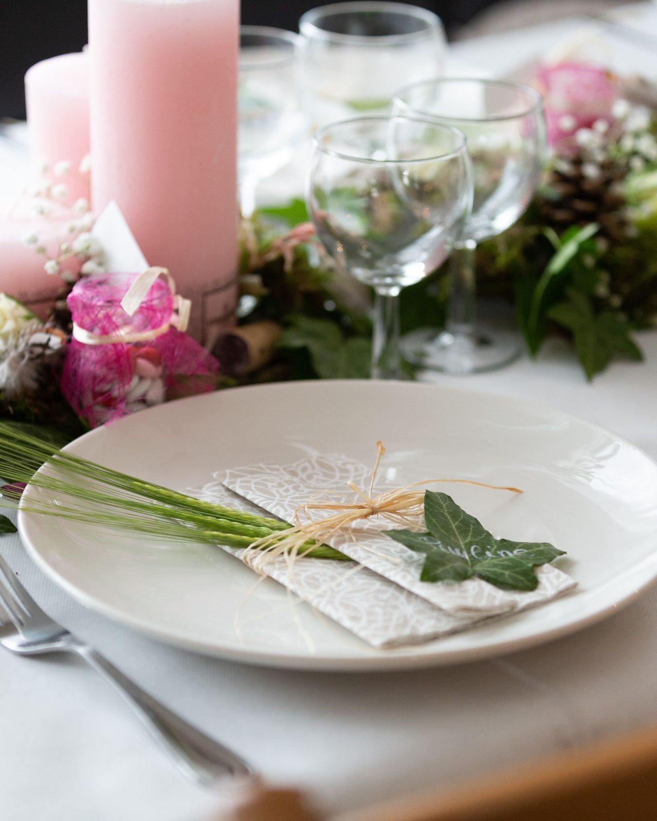 Beautifully arranged wedding table setting with floral centerpiece and candles for an elegant reception.