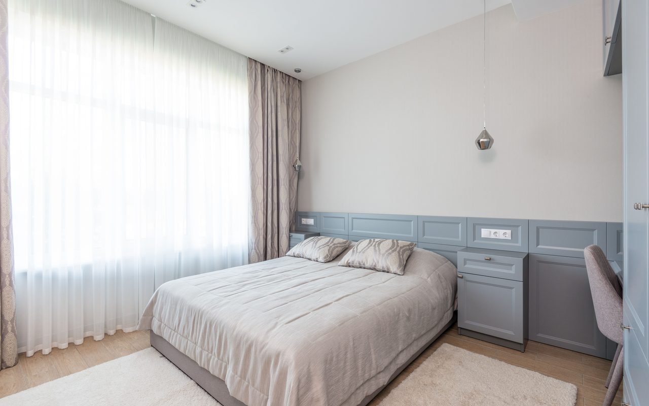 Elegant hotel bedroom with minimalist design and calming neutral tones.