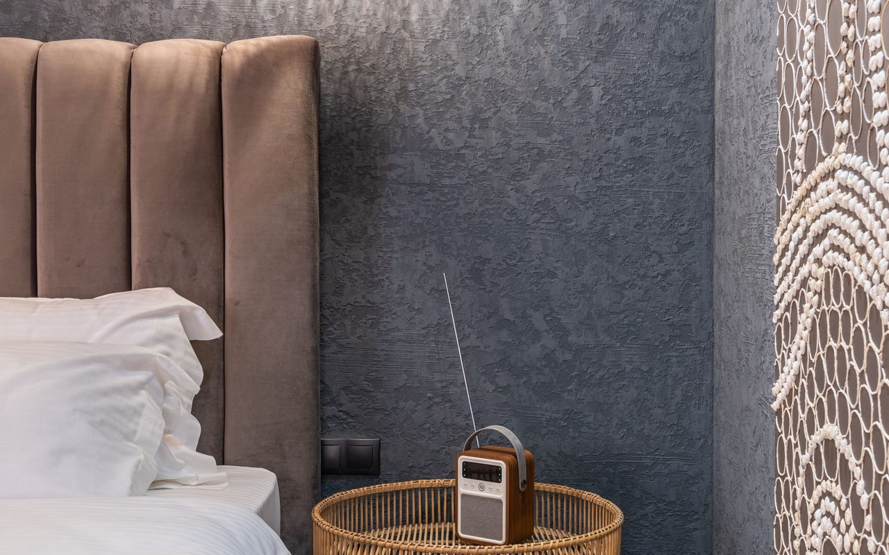 A cozy, modern bedroom with elegant lighting and decor for a luxurious feel.