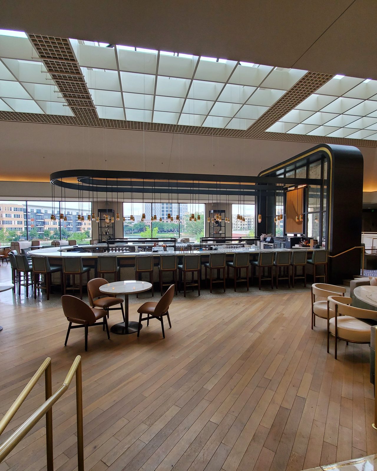 Luxurious and spacious hotel lobby with elegant decor and natural lighting.
