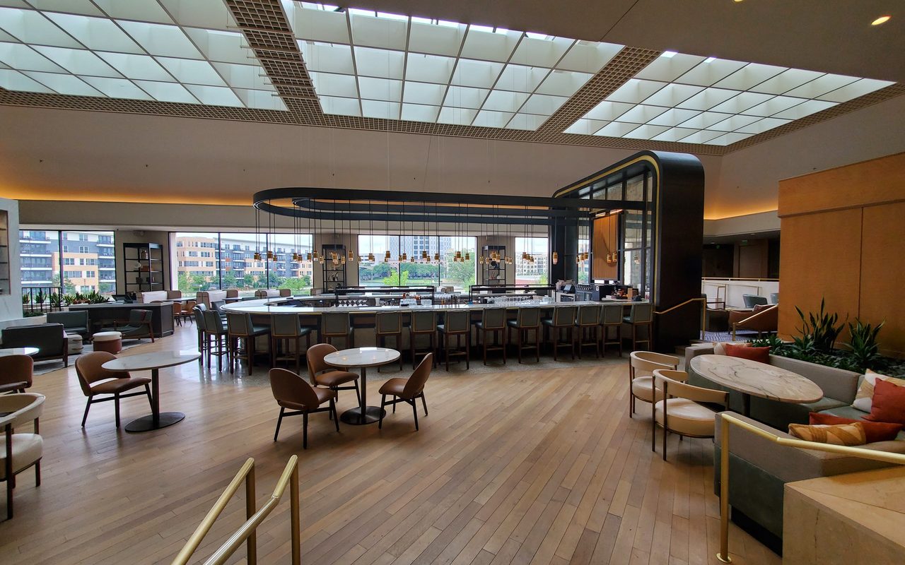 Luxurious and spacious hotel lobby with elegant decor and natural lighting.