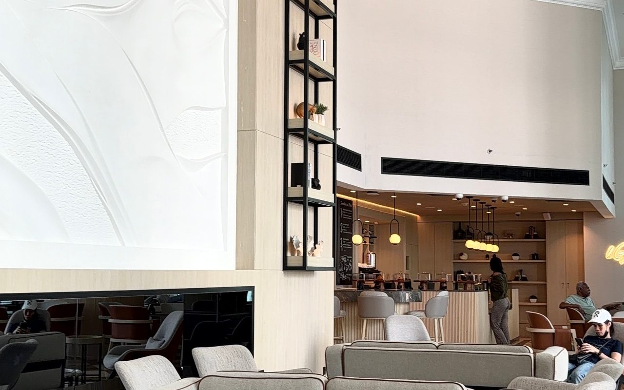 Spacious hotel lobby with contemporary decor and comfortable seating in natural lighting.