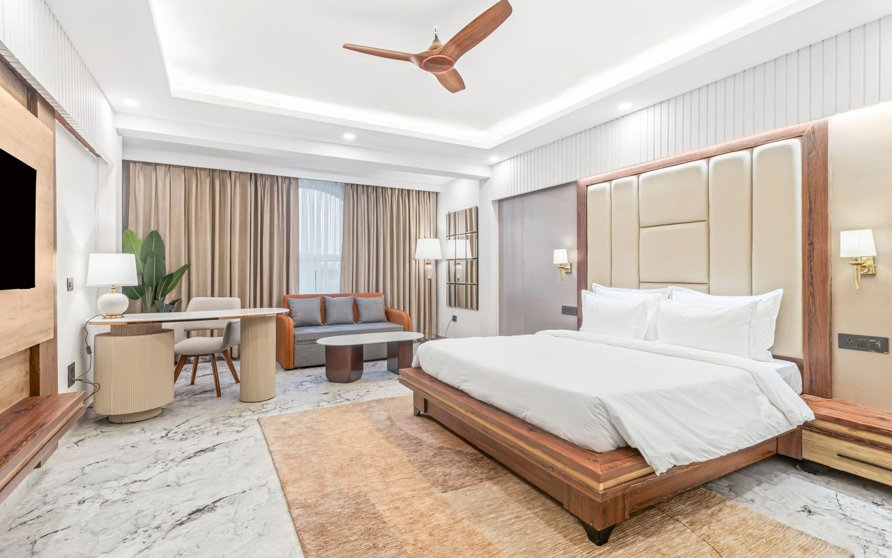 Spacious modern bedroom with elegant furniture, perfect for luxury accommodation settings.