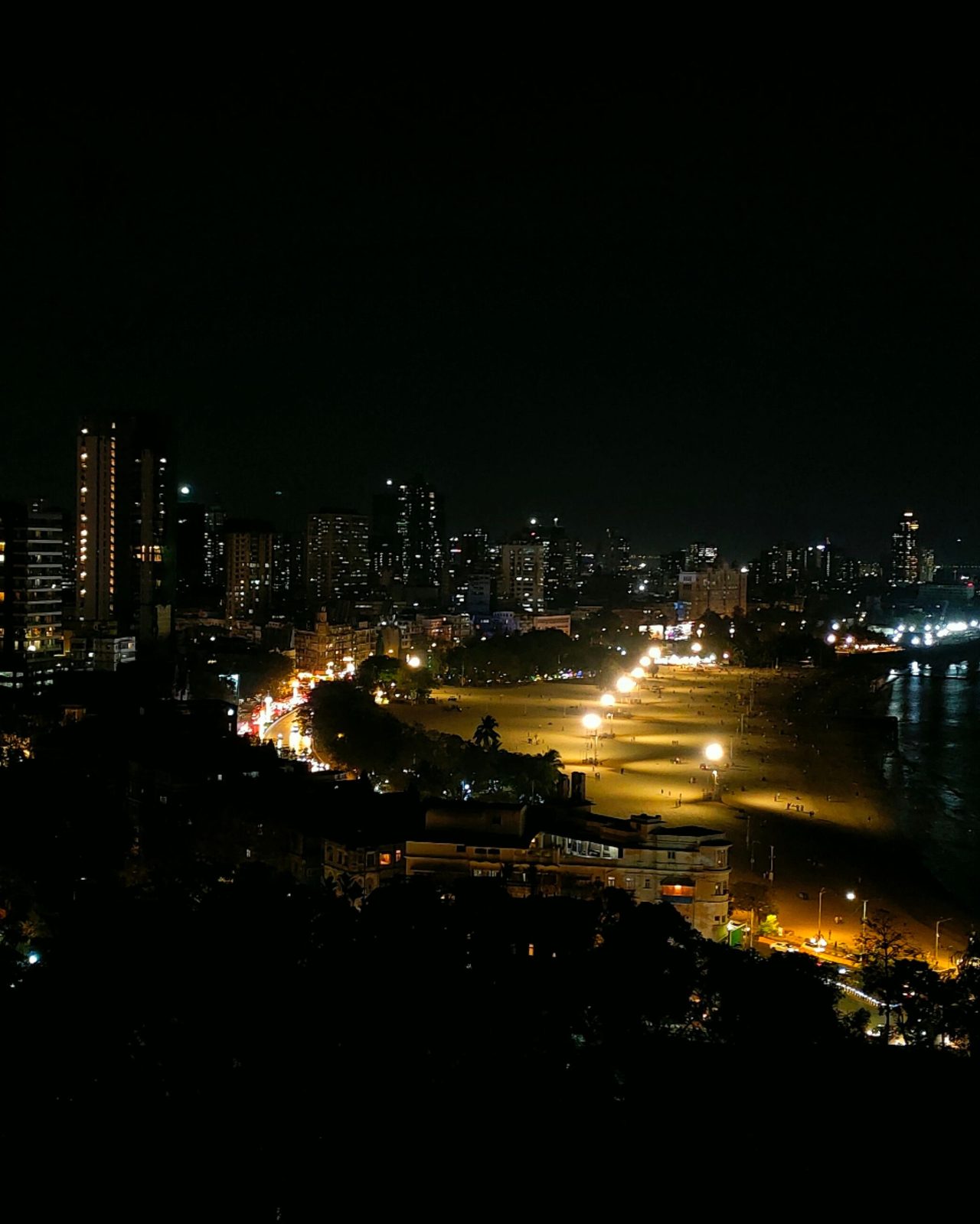 Stunning nighttime landscape of Mumbai's illuminated skyscrapers along Marine Drive.