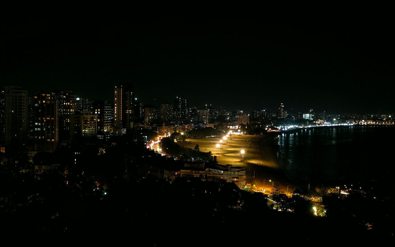 Stunning nighttime landscape of Mumbai's illuminated skyscrapers along Marine Drive.