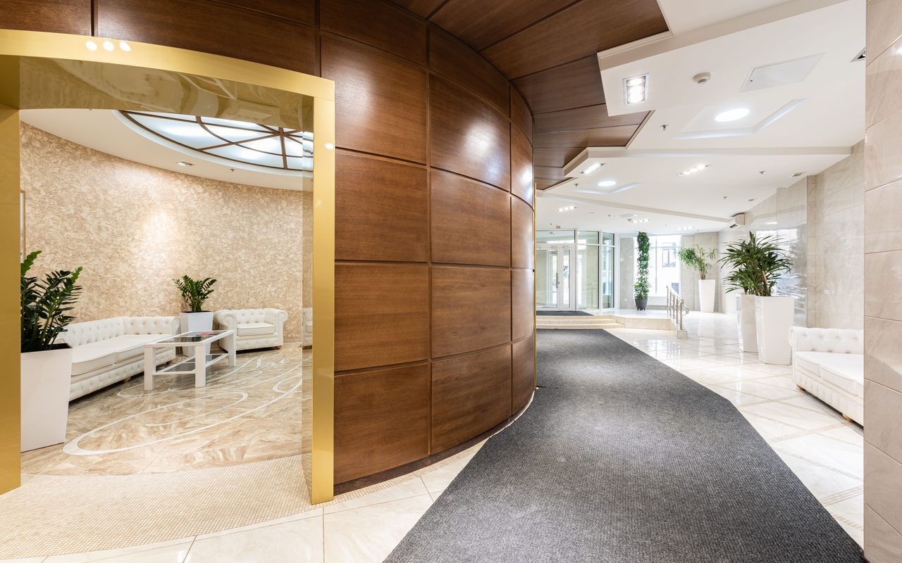 A spacious and luxurious hotel lobby with contemporary decor and natural lighting.