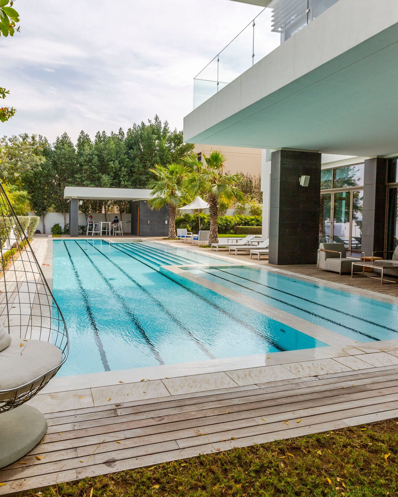 a modern luxury villa featuring a sleek swimming pool and spacious terrace in Dubai.