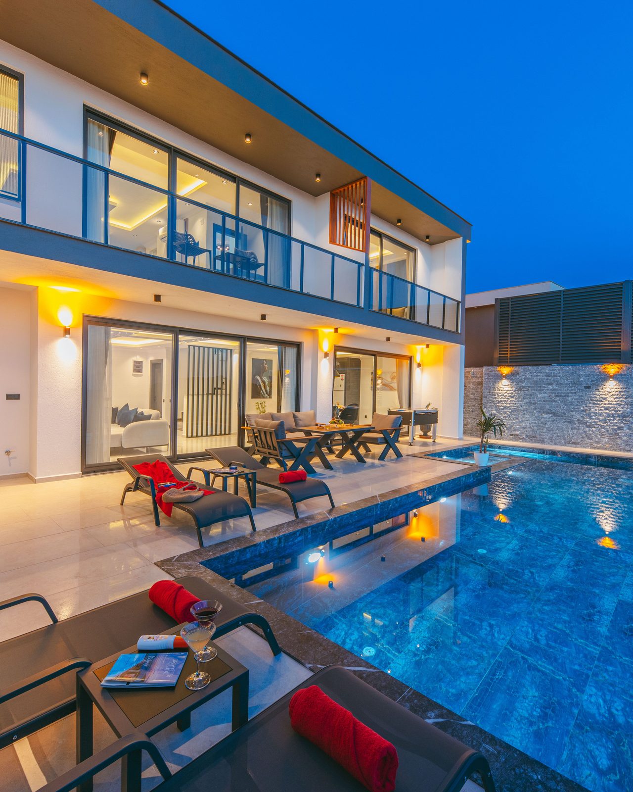 A tranquil evening at a modern luxury villa with a stunning poolside ambiance, perfect for relaxation and vacation.