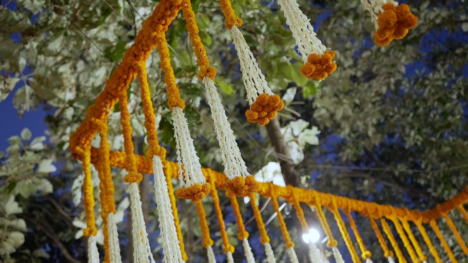 Marigold and white flower garlands forming an Indian wedding canopy