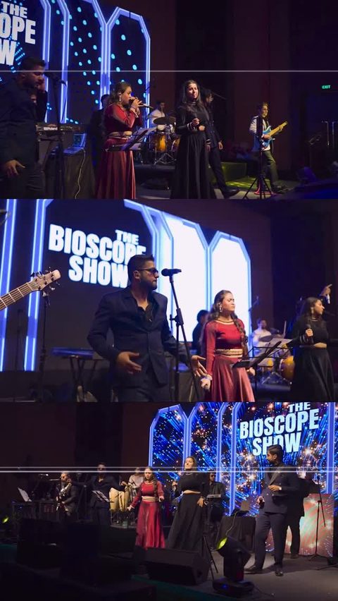 The seven members of the band posing together in front of a Bioscope Show backdrop at The Bioscope Show.