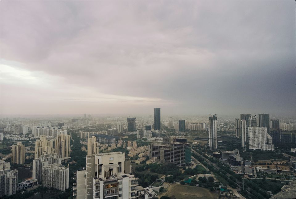 Gurugram skyline beneath a cloudy sky