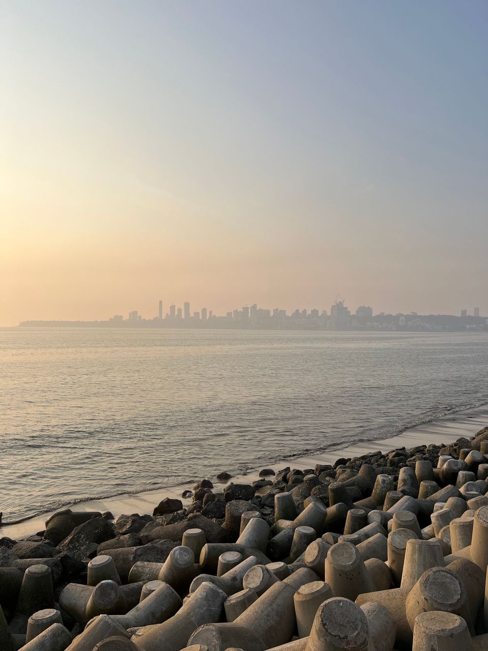 Concrete wave breakers beside the sea in Mumbai at dusk