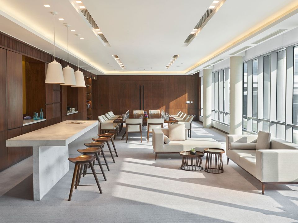 Bright event lounge with tables and tall windows