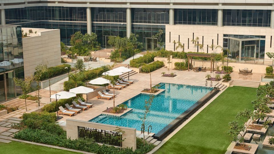 Outdoor swimming pool within a landscaped courtyard