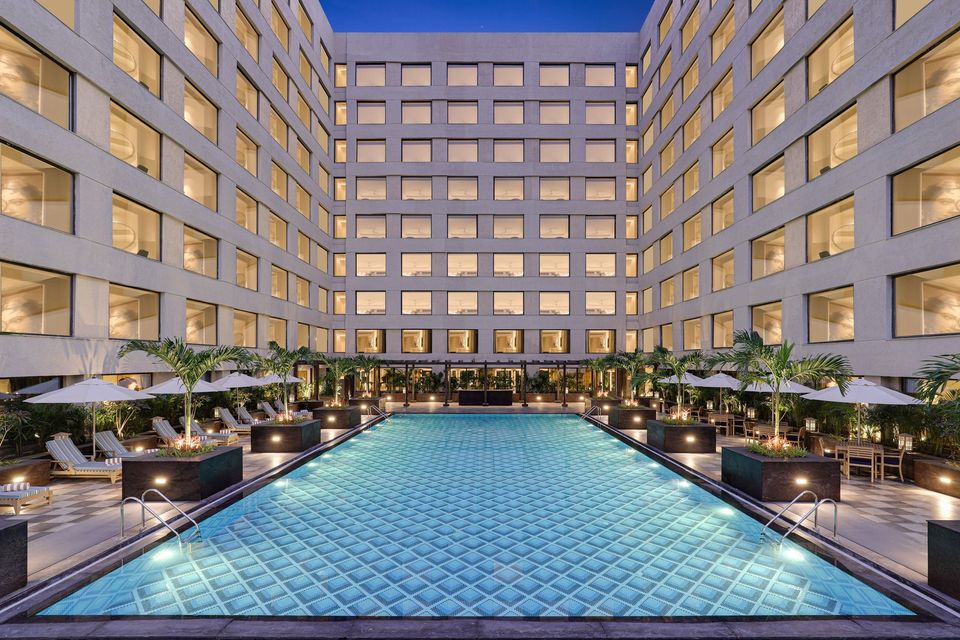 Courtyard swimming pool framed by hotel wings