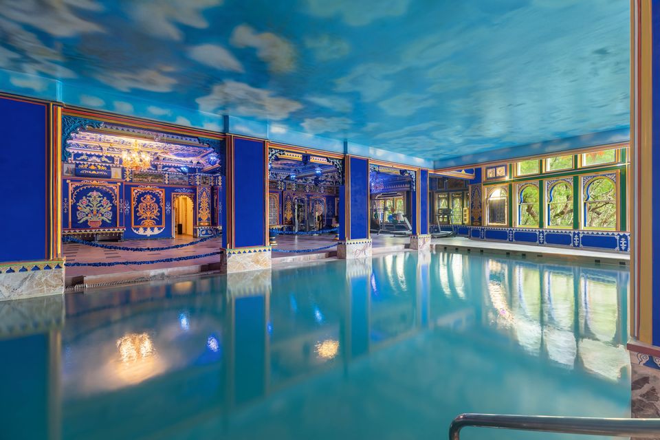 Indoor pool beneath a painted ceiling