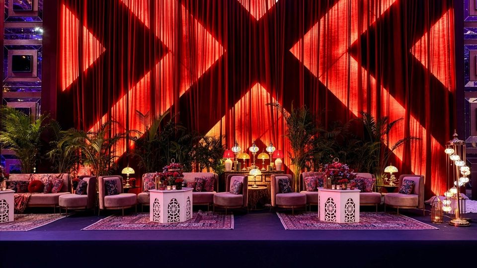 Lounge seating against illuminated red drapes