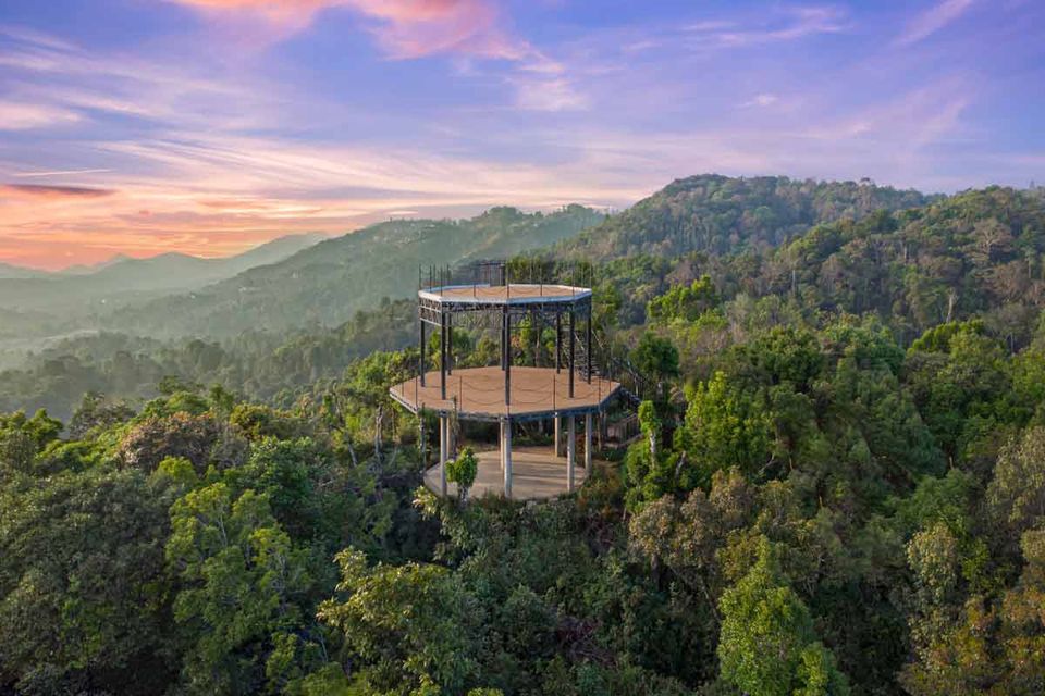 Resort lookout above forested hills at sunset