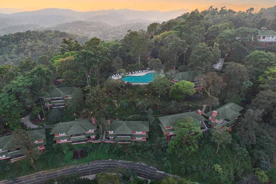 Resort buildings and pool across forested hills