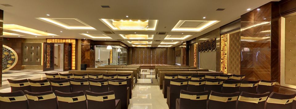 Event hall with rows of upholstered chairs