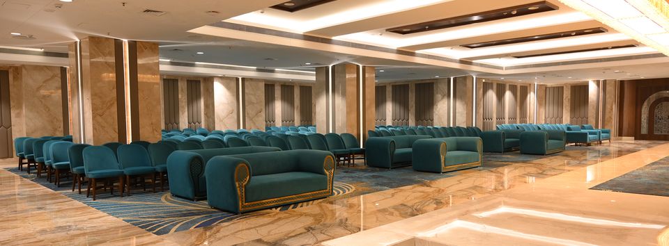 Marble event hall with blue upholstered seating
