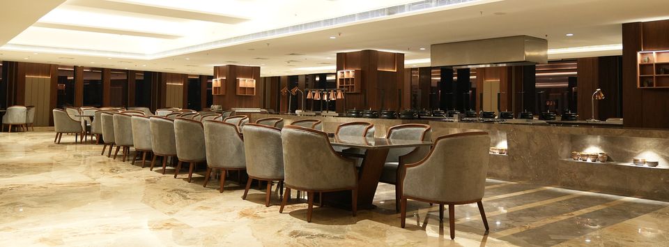 Banquet tables beneath a decorative ceiling