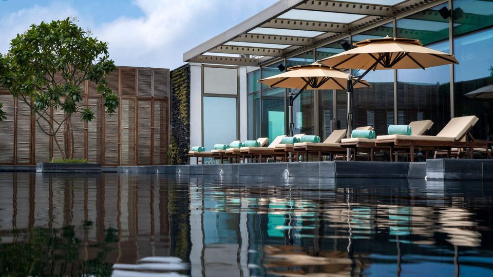 Rooftop pool with shaded loungers