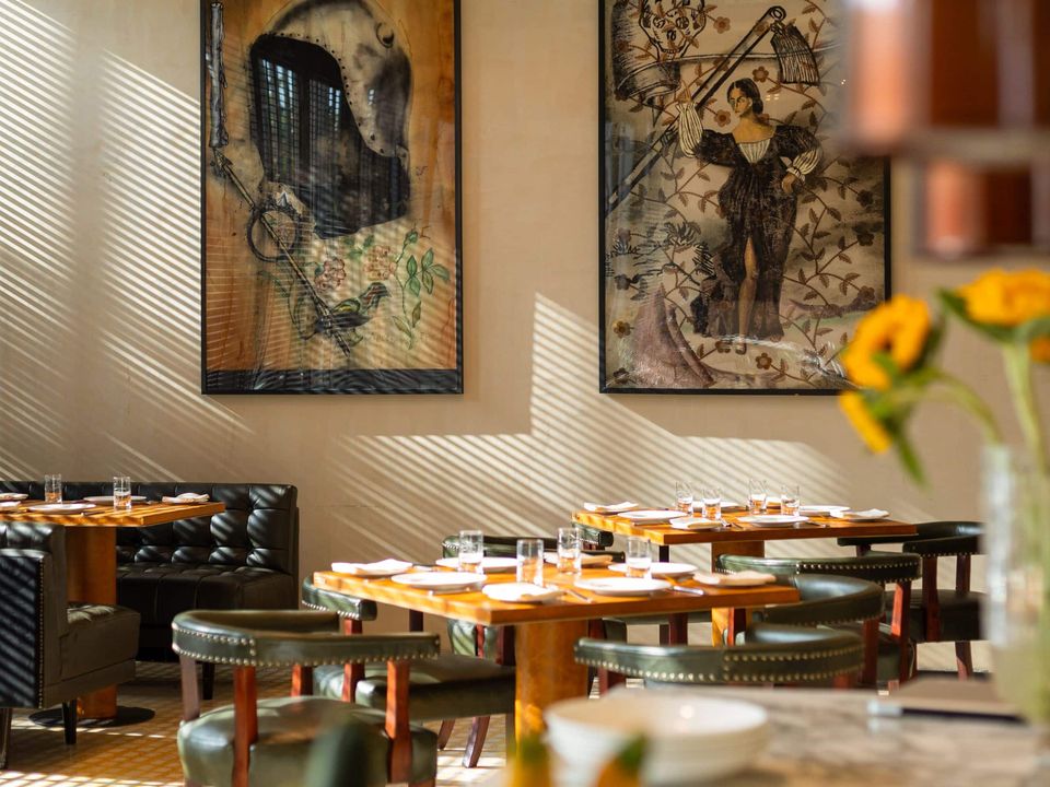 Restaurant tables beneath framed wall art