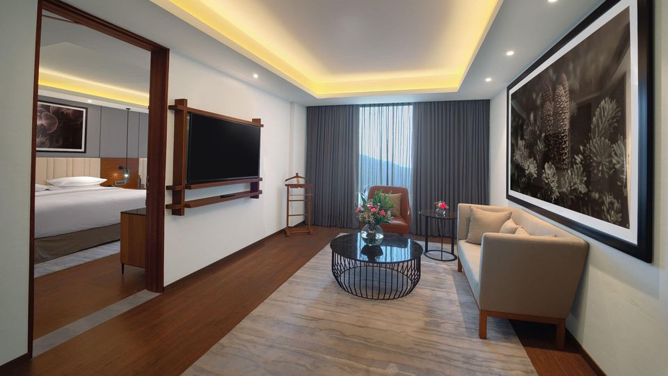 Suite living room with recessed ceiling lighting