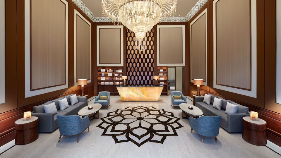 Spa reception lounge beneath a large chandelier