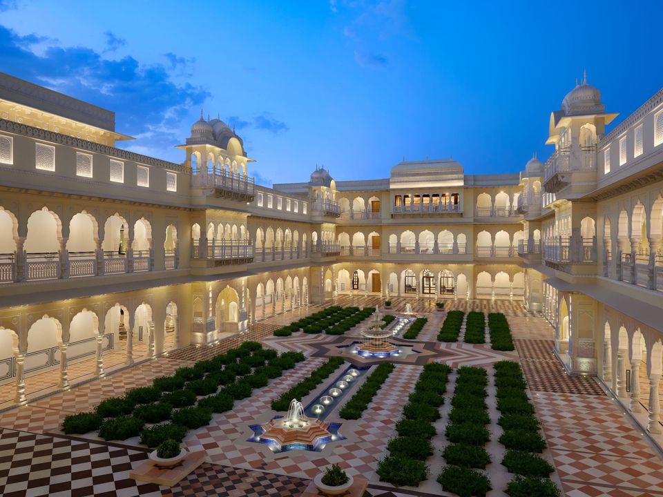 Illuminated courtyard with formal gardens and arcades