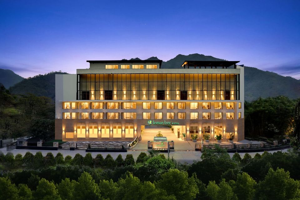 Hotel facade illuminated against the hills
