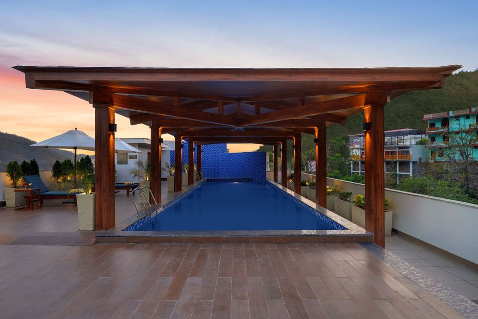 Rooftop swimming pool beneath a timber pergola