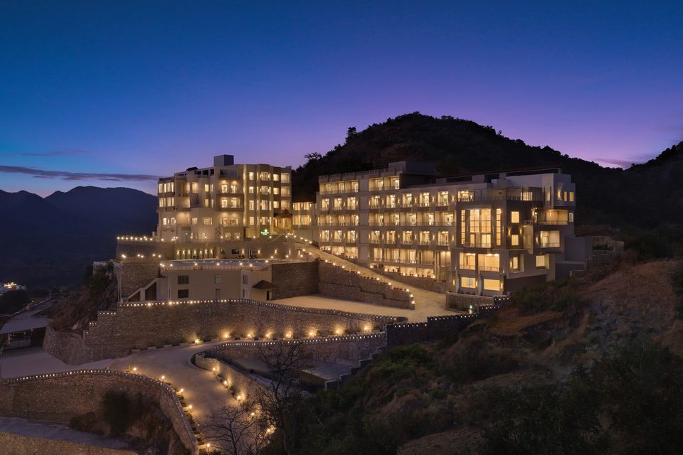Hillside hotel illuminated at dusk