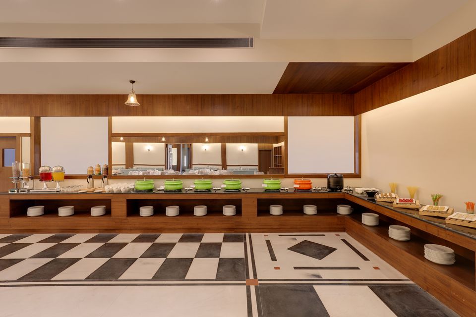 Restaurant buffet beneath a coffered ceiling