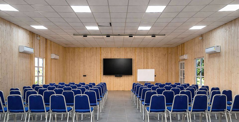 Conference room arranged with blue chairs