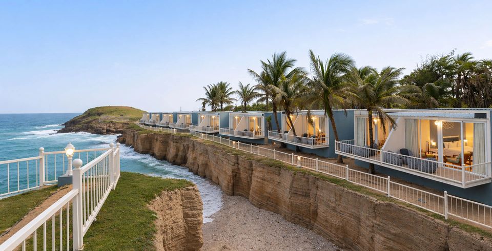 Sea-facing cottages above a rocky coastline