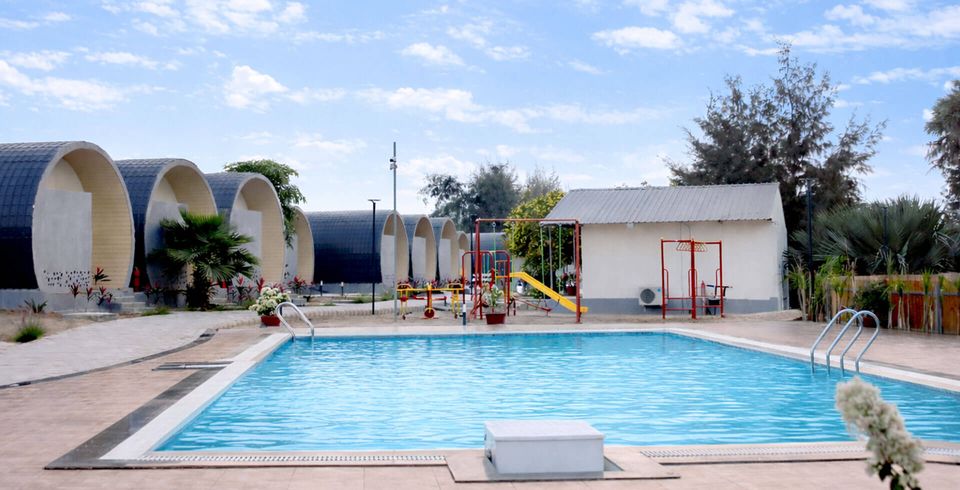 Outdoor swimming pool beside the cottages