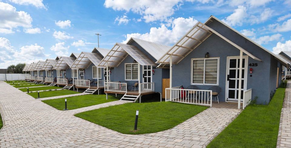 Pitched-roof cottages beside lawns and paths