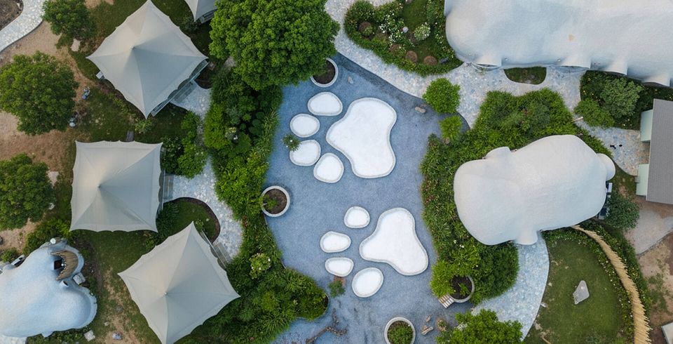 Aerial view of cave-style cottages and pool