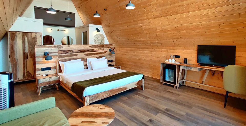 Timber cottage bedroom with a high ceiling