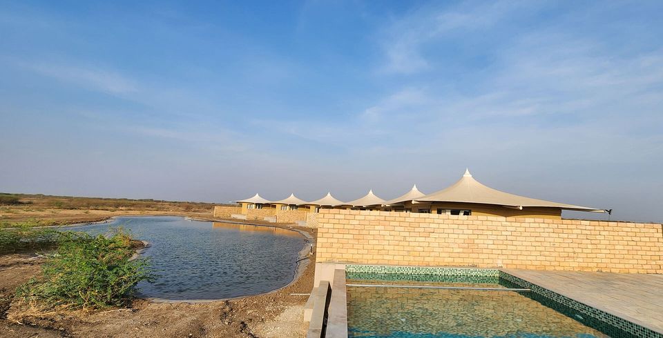 Pool and lake beside tented accommodation
