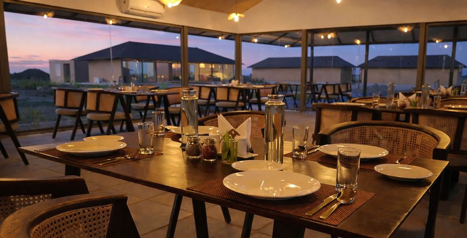 Dining terrace overlooking illuminated cottages