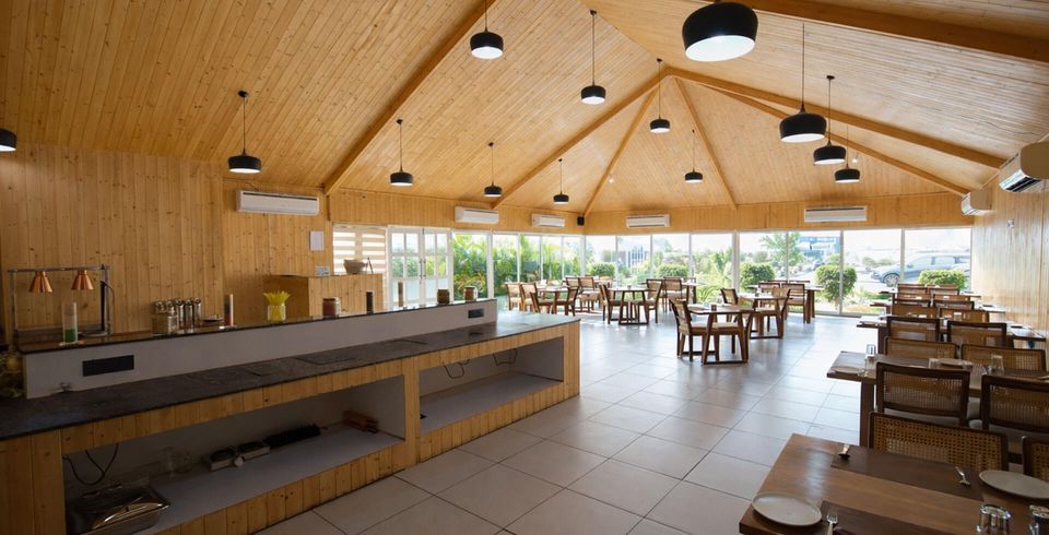 Wood-lined restaurant with garden-facing windows