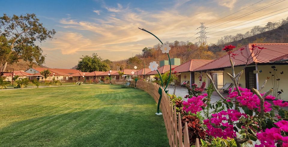 Landscaped lawn beside tented accommodation at sunset