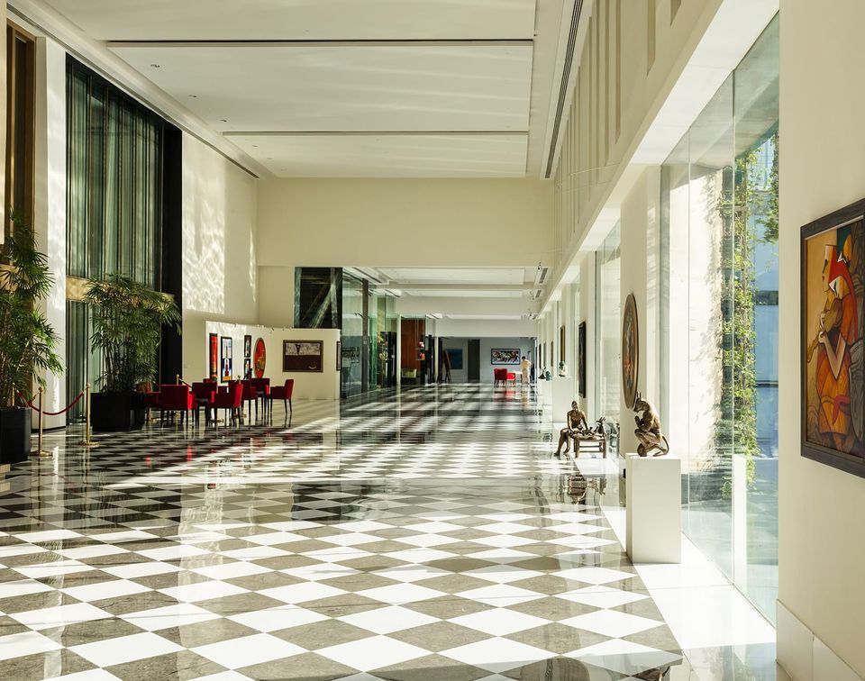 Sunlit marble corridor with a chequered floor