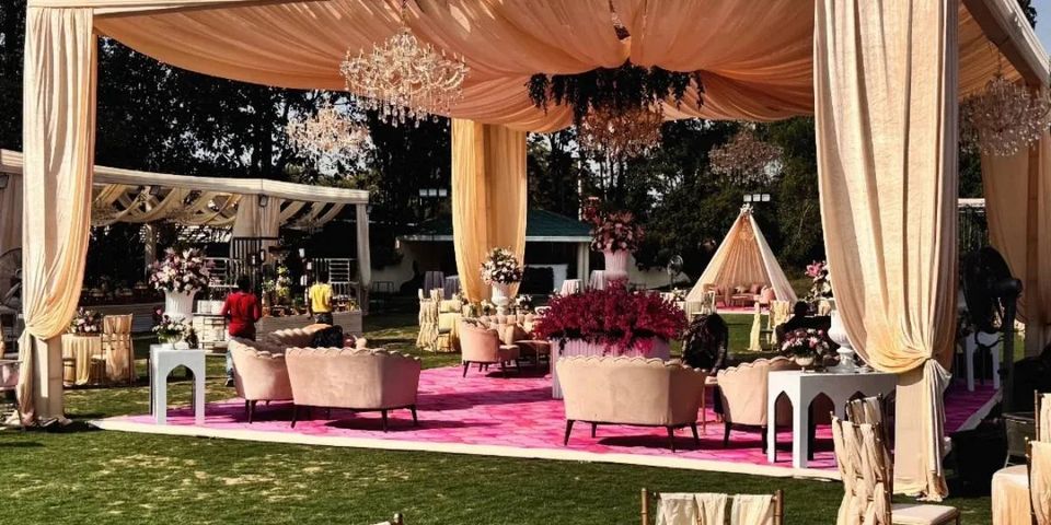 Garden lounge arranged beneath a fabric canopy
